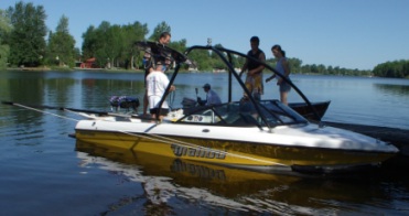   [ Volunteers getting a boat ready at the dock! Boom on, tower and bimini in place, safety equipment checked. ]